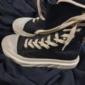 Black High-Top Sneakers with White Soles